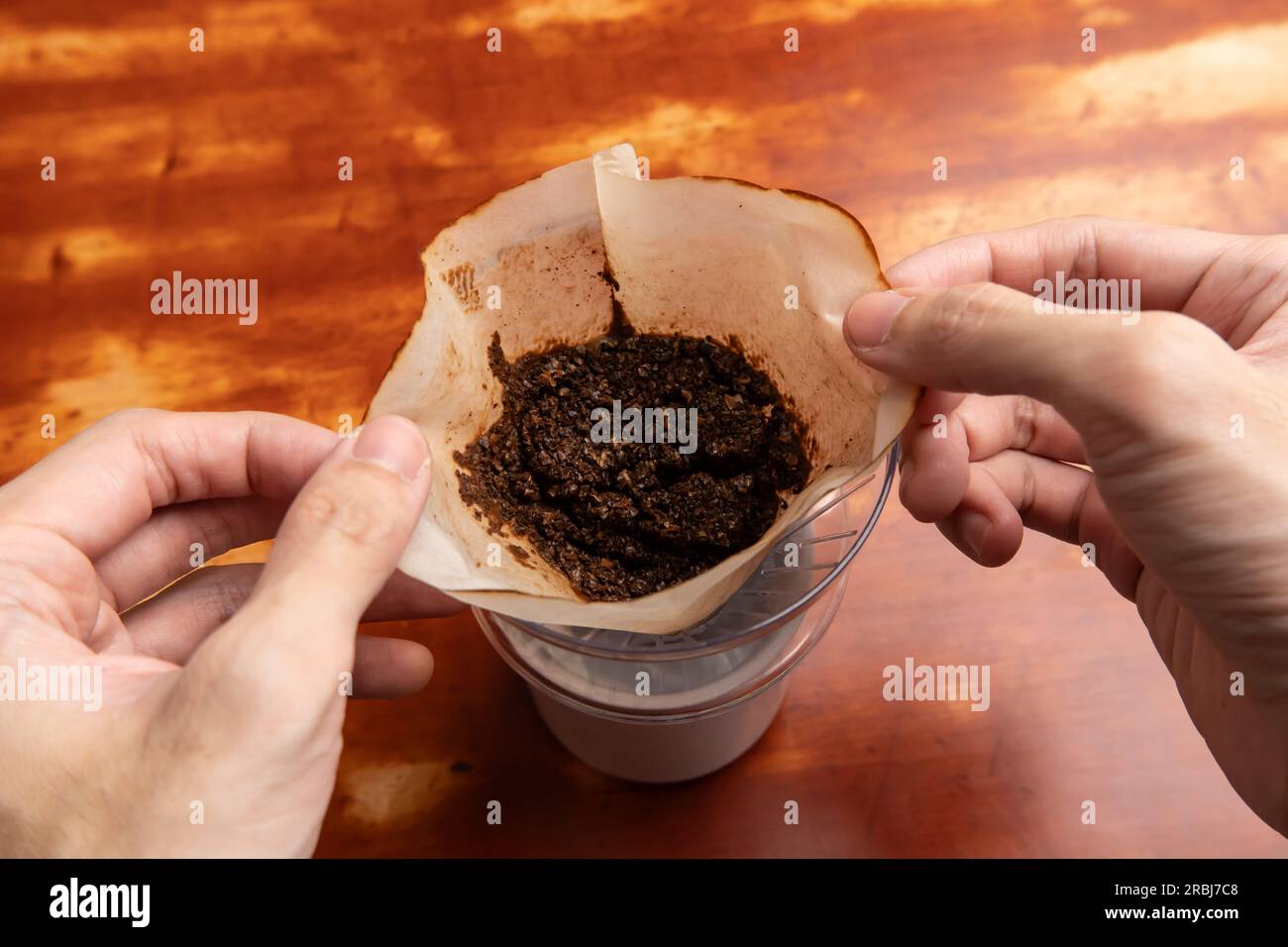 Used coffee ground left in a coffee dripper. Coffee grounds can be used as a fertilizer. Stock Photo