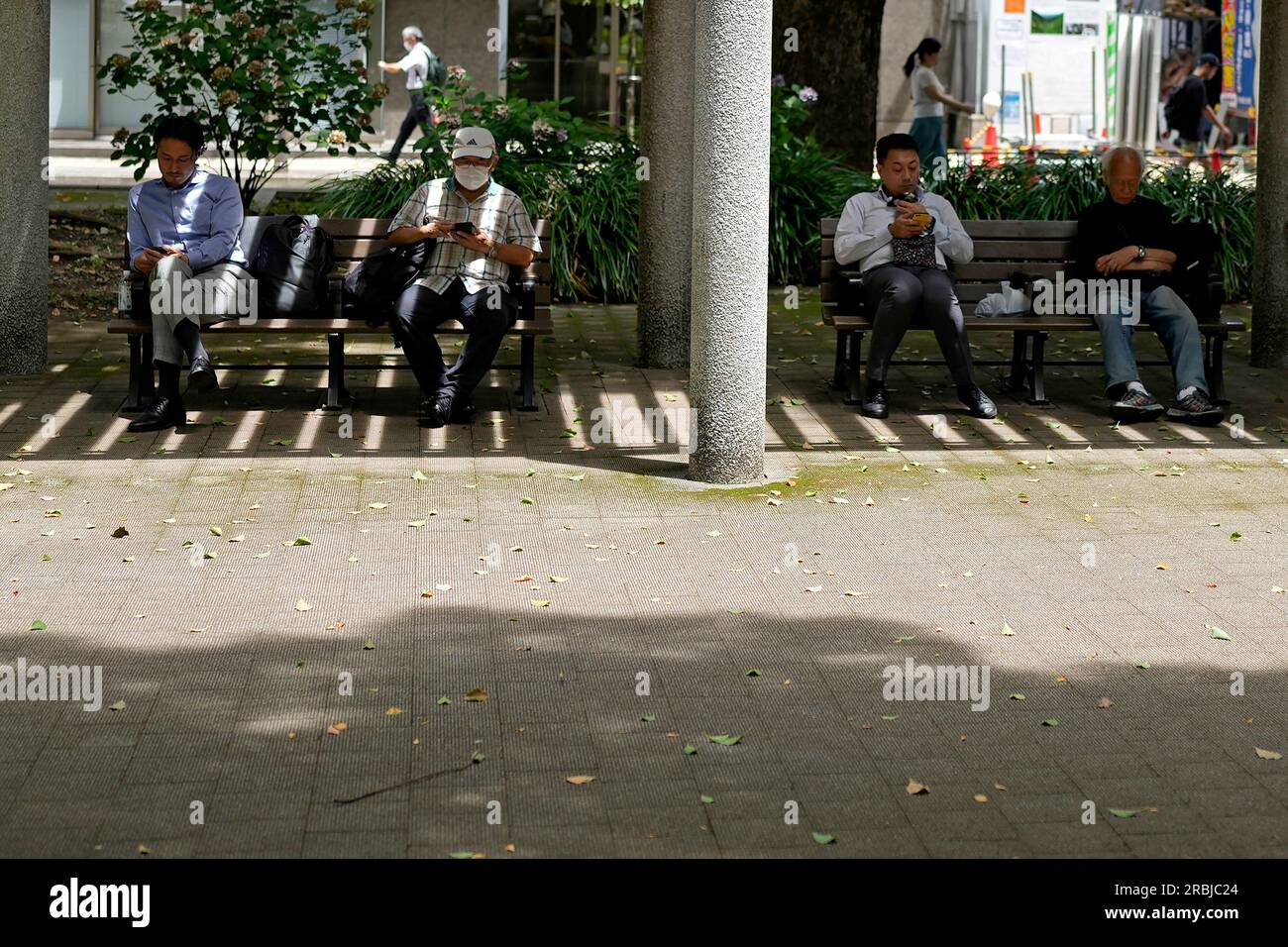 People rest in shade at a park in Tokyo, Friday, July 7, 2023, in Tokyo