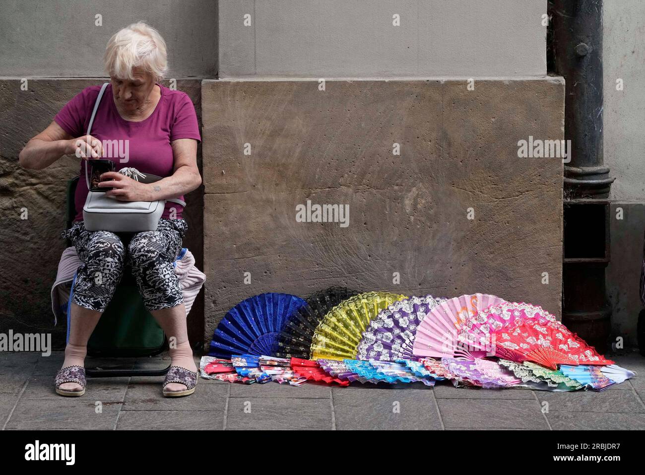 A street vendor sells fans during a hot summer day, in downtown Warsaw