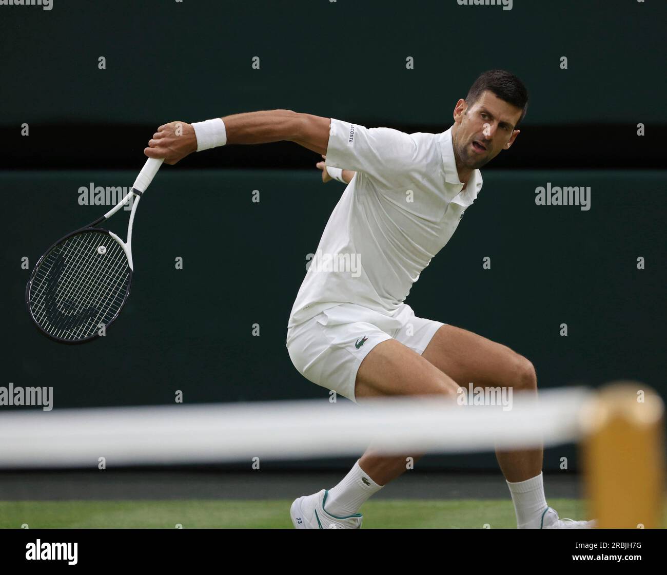 Novak Djokovic of Serbia hits a ball during the gentlemens singles third-round match against Stan Wawrinka of Switzerland in the Championships, Wimbledon at All England Lawn Tennis and Croquet Club in London,