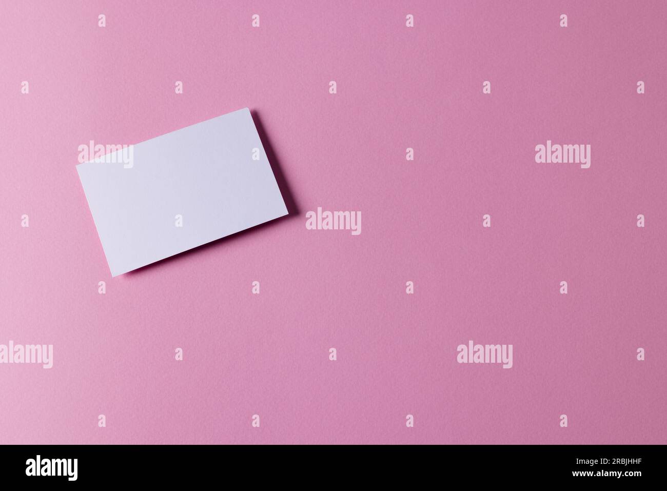 White business card with copy space on pink background Stock Photo