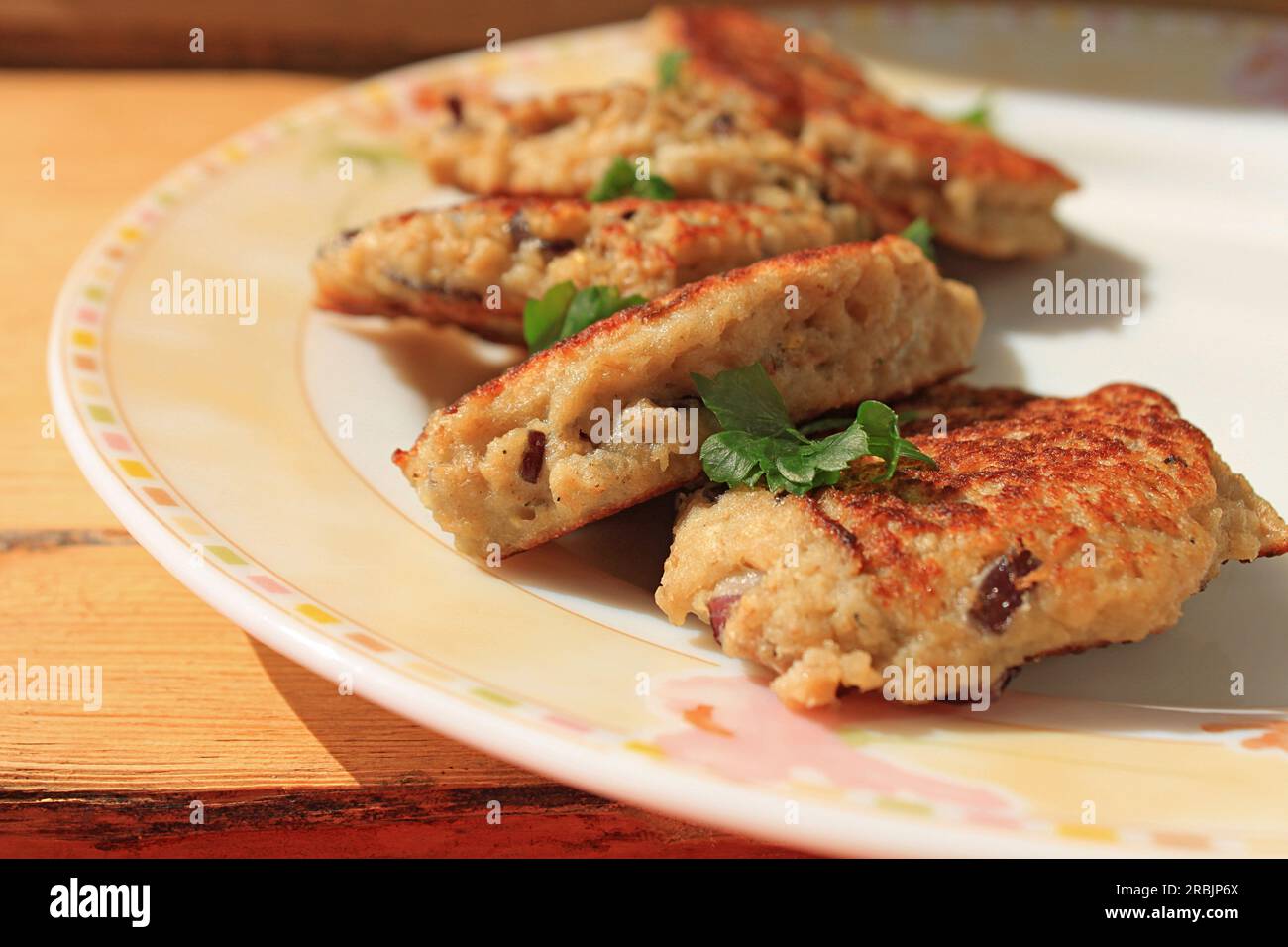 Hake cutlets with green, purple onions and oatmeal. Dietary healthy lowfat fish cutlets. Proper