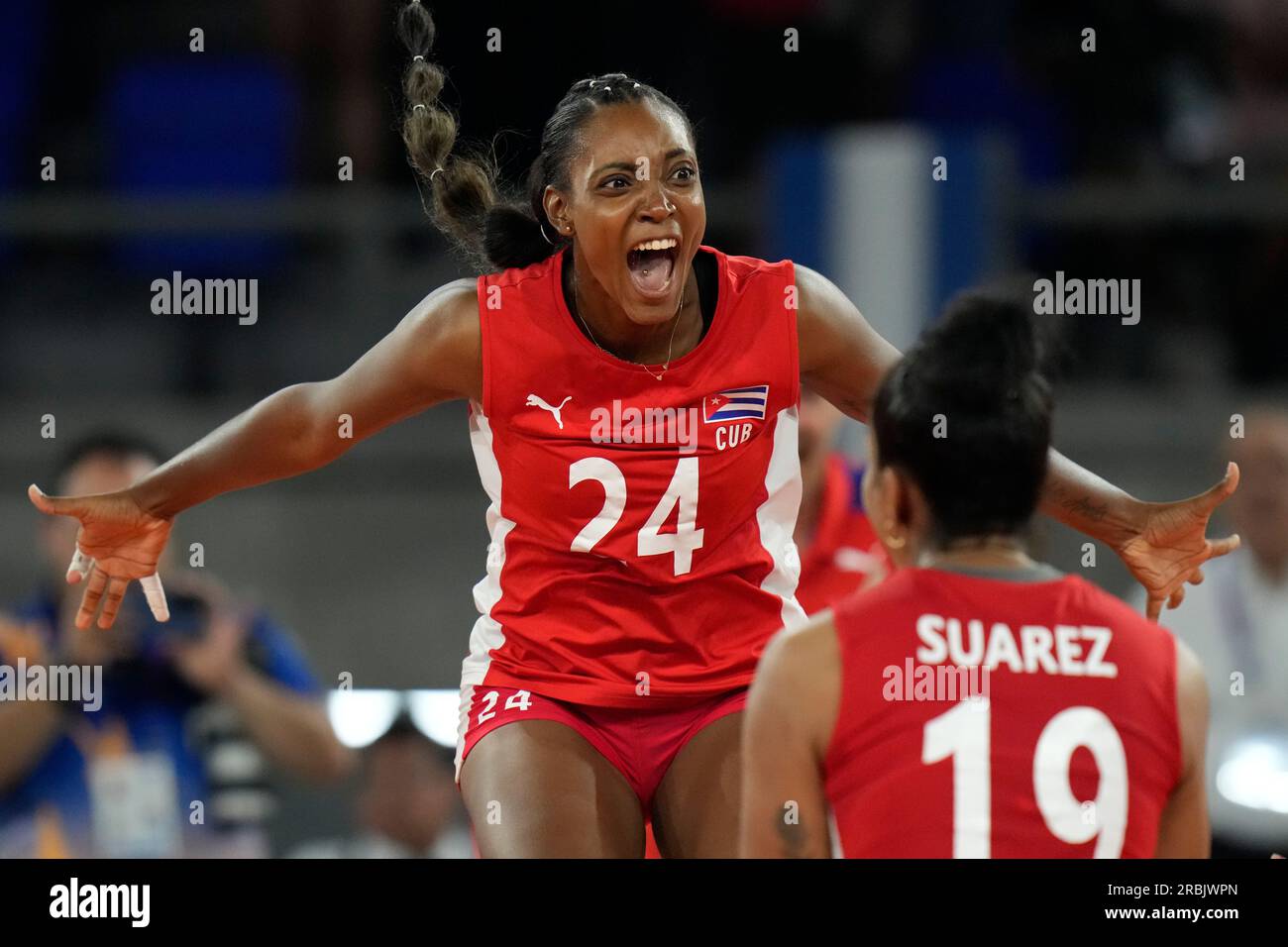 Cuba's Thalia Morenos celebrates with teammate Laura Suarez, their victory  over Colombia, at the end of the women's volleyball team final for the  bronze medal, at the Central American and Caribbean Games