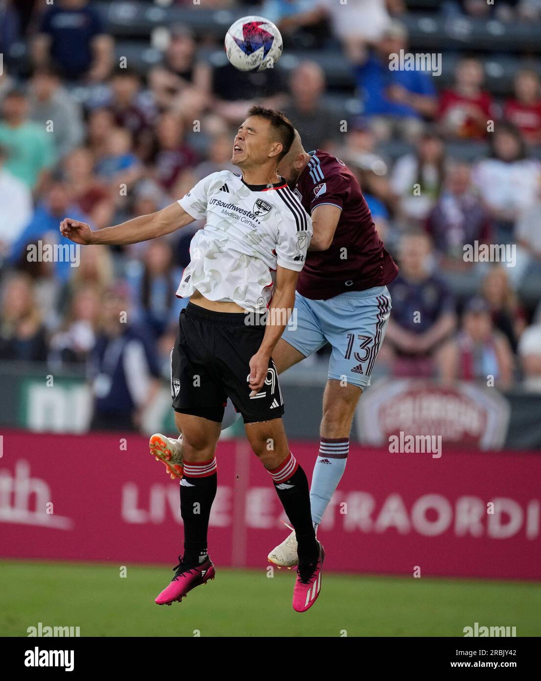 FC Dallas defender Sam Junqua,left, heads the ball as Colorado Rapids  defender Andrew Guttman (13) covers in the first half of an MLS soccer  match Saturday, July 8, 2023, in Commerce City