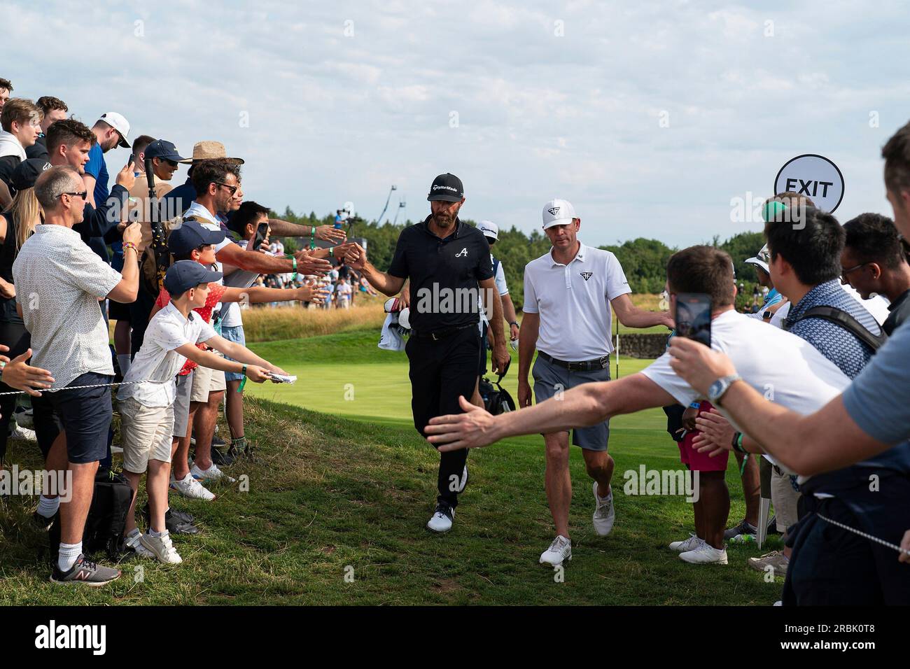 Captain Dustin Johnson of 4Aces GC and Brendan Steele of HyFlyers GC high  five fans during the second round of LIV Golf London at the Centurion Club  on Saturday, July 08, 2023