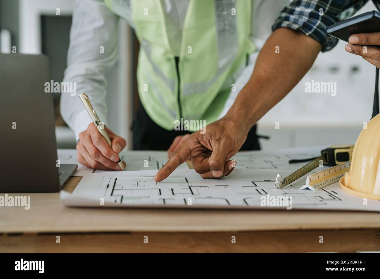 multi ethnic engineer brainstorming and measuring for cost estimating