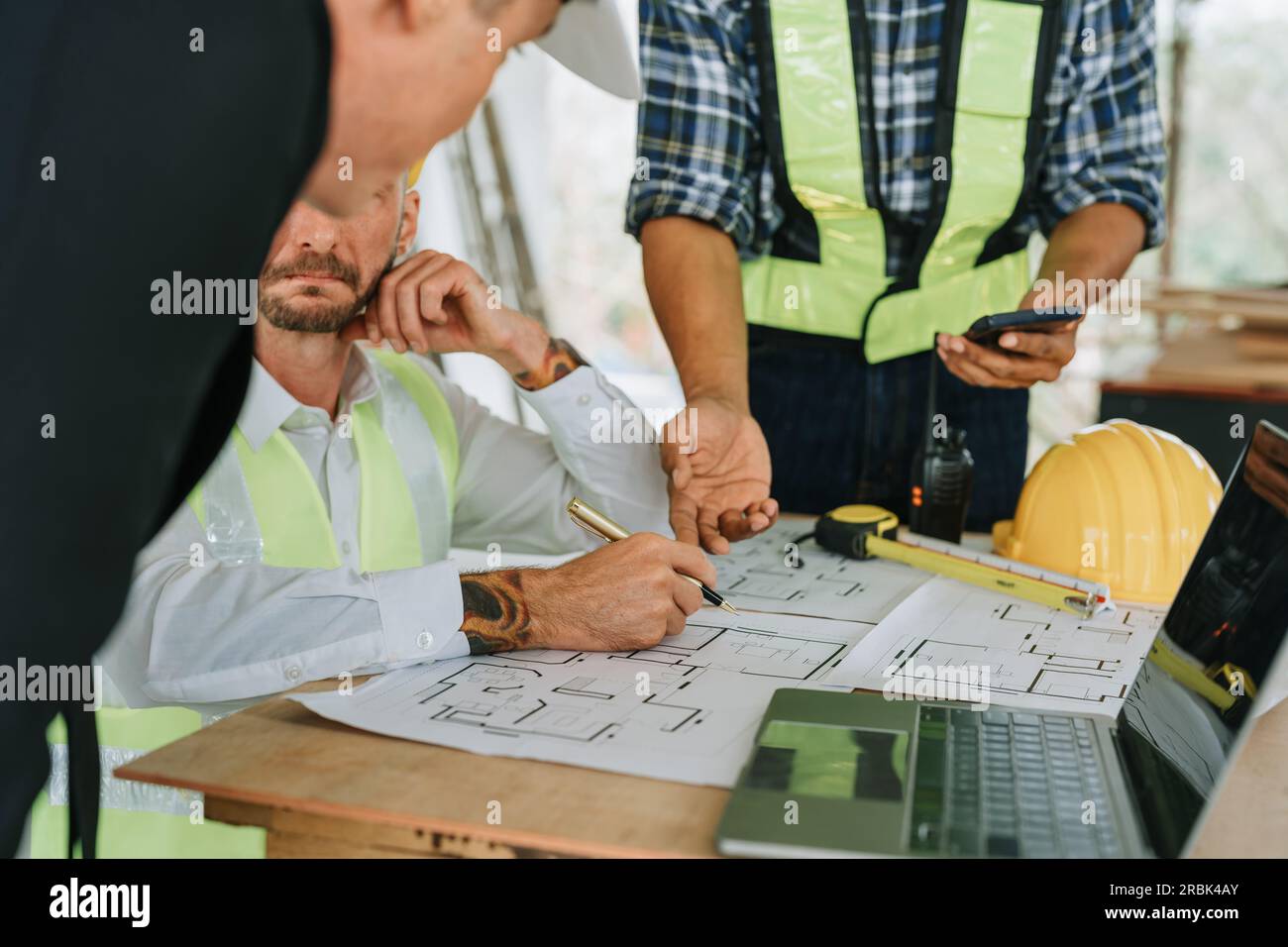 multi ethnic engineer brainstorming and measuring for cost estimating