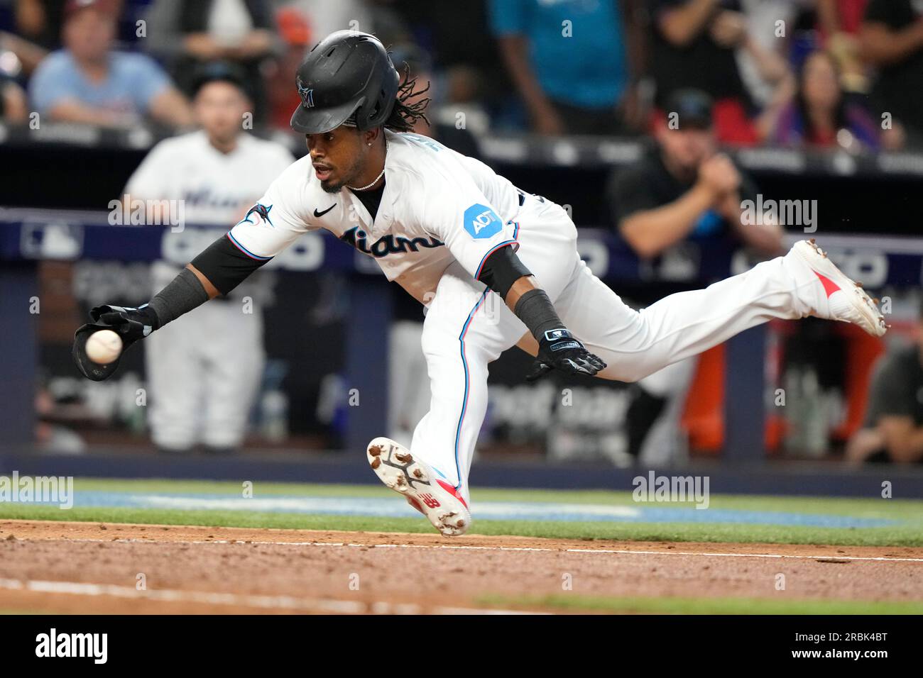 Miami Marlins' Jean Segura runs to beat the throw by Philadelphia Phillies  second baseman Bryson Stott but is out at the plate during the eighth  inning of a baseball game, Sunday, July