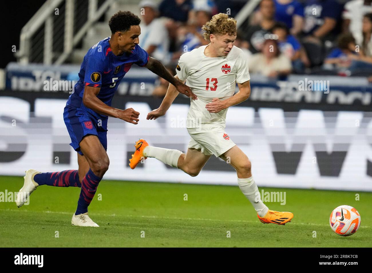 Canada forward Jacob Shaffelburg (13) moves the ball against United States  defender Bryan Reynolds (5) in extra time during a CONCACAF Gold Cup  semi-final soccer match, Sunday, July 9, 2023, in Cincinnati. (