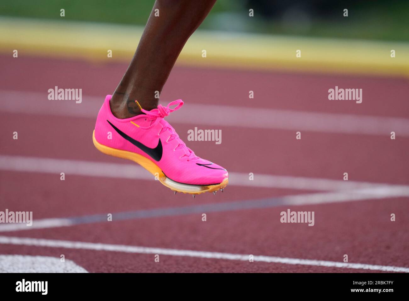 An athlete wears a pink shoe in competition during the U.S. track and