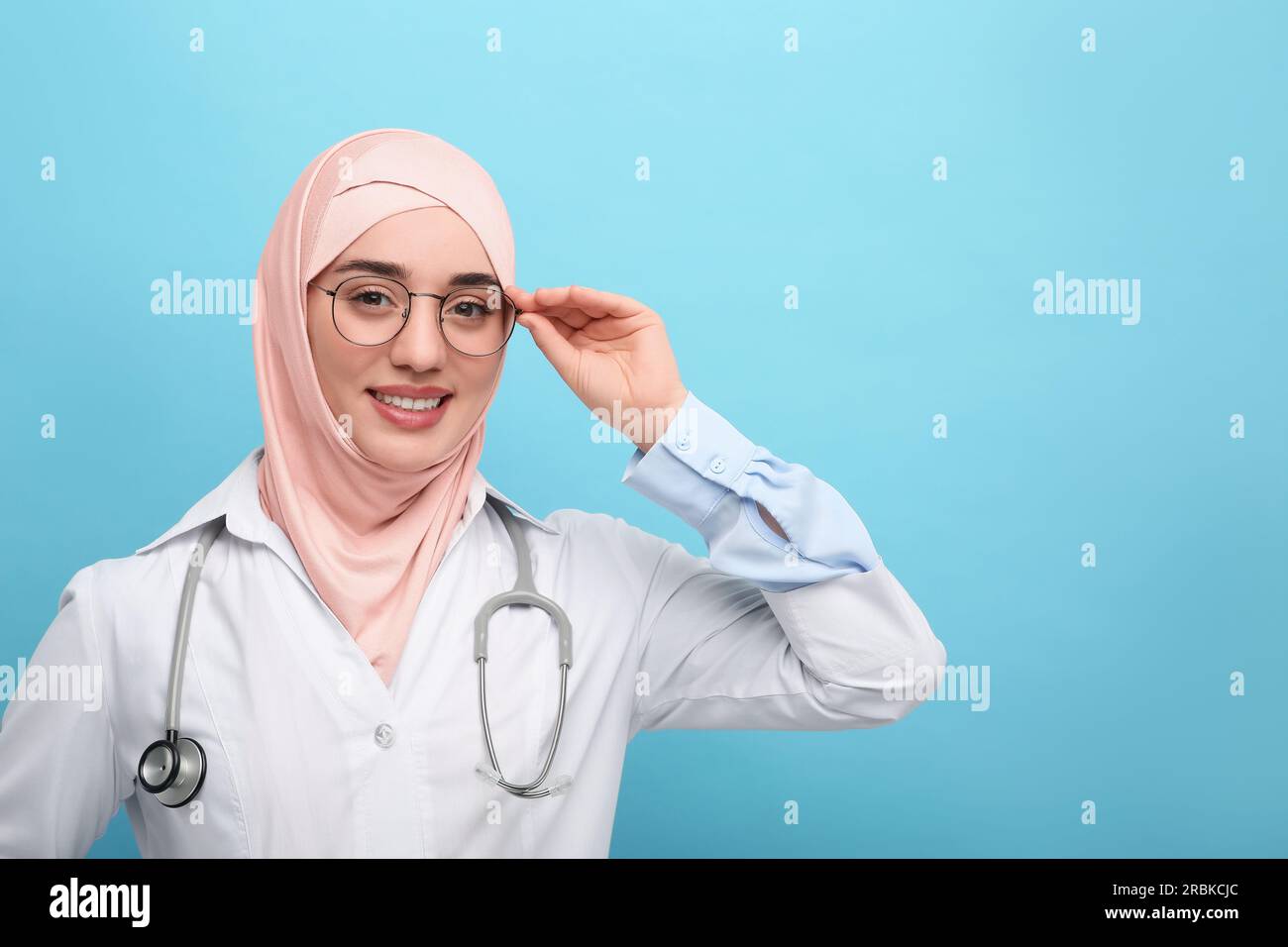 Muslim woman wearing hijab and medical uniform with stethoscope on