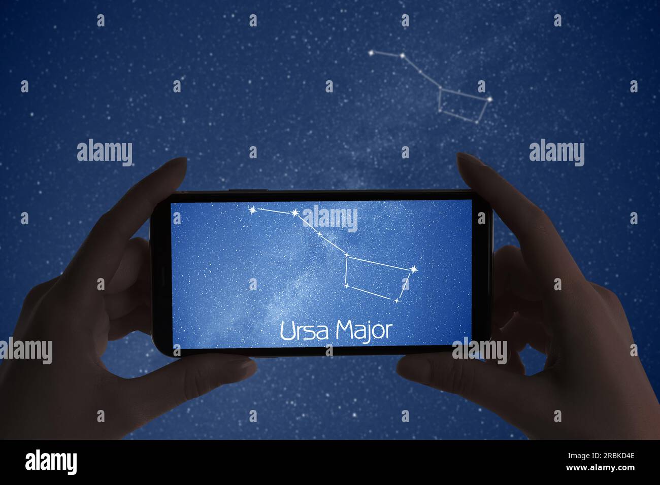 Woman using stargazing app on her phone at night, closeup. Identified stick figure pattern of Great Bear (Ursa Major) constellation on device screen Stock Photo