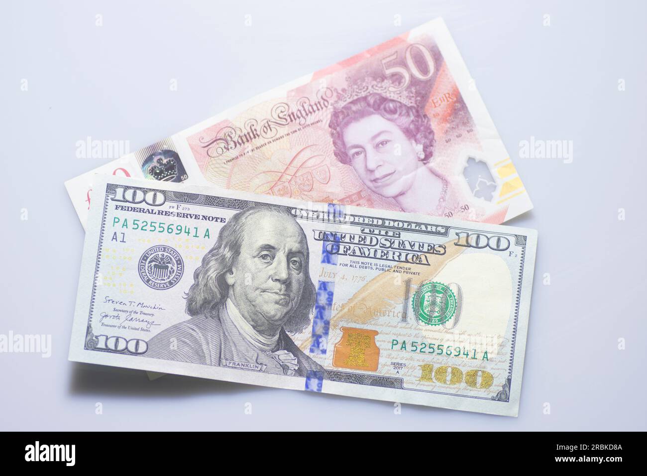 100 US Dollars with 50 pounds sterling Stock Photo