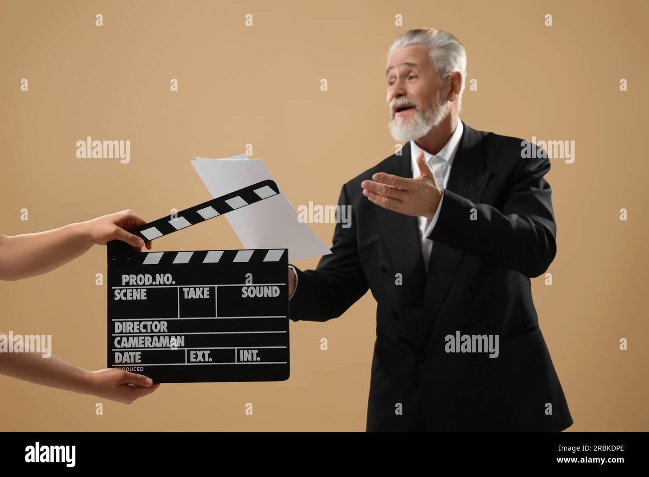 Senior actor performing role while second assistant camera holding ...