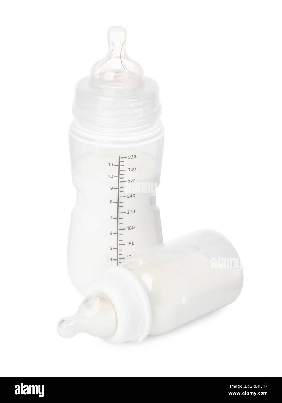 Two feeding bottles with infant formula on white background Stock Photo