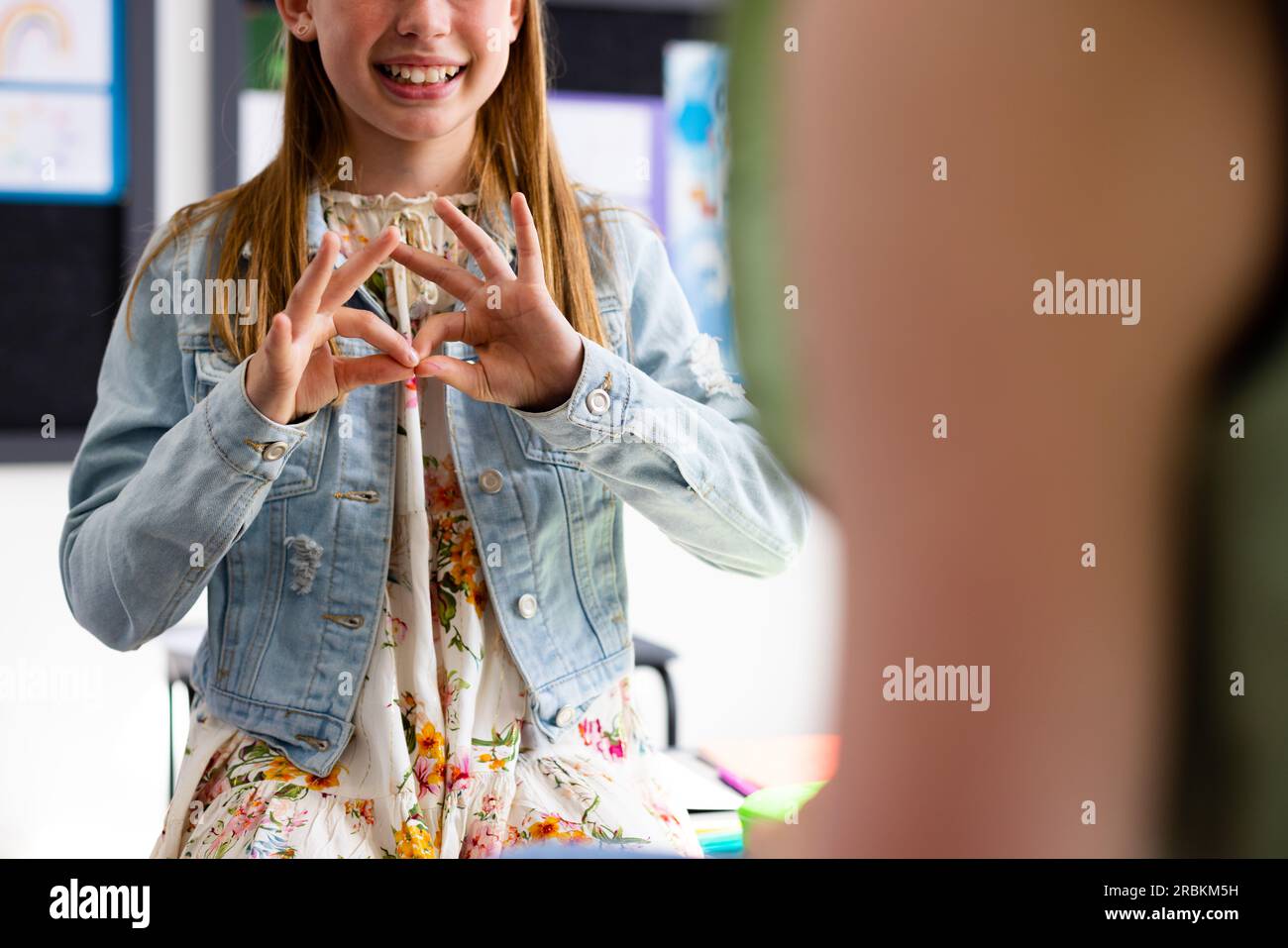 Happy diverse schoolchildren using sign language in school classroom Stock Photo Alamy