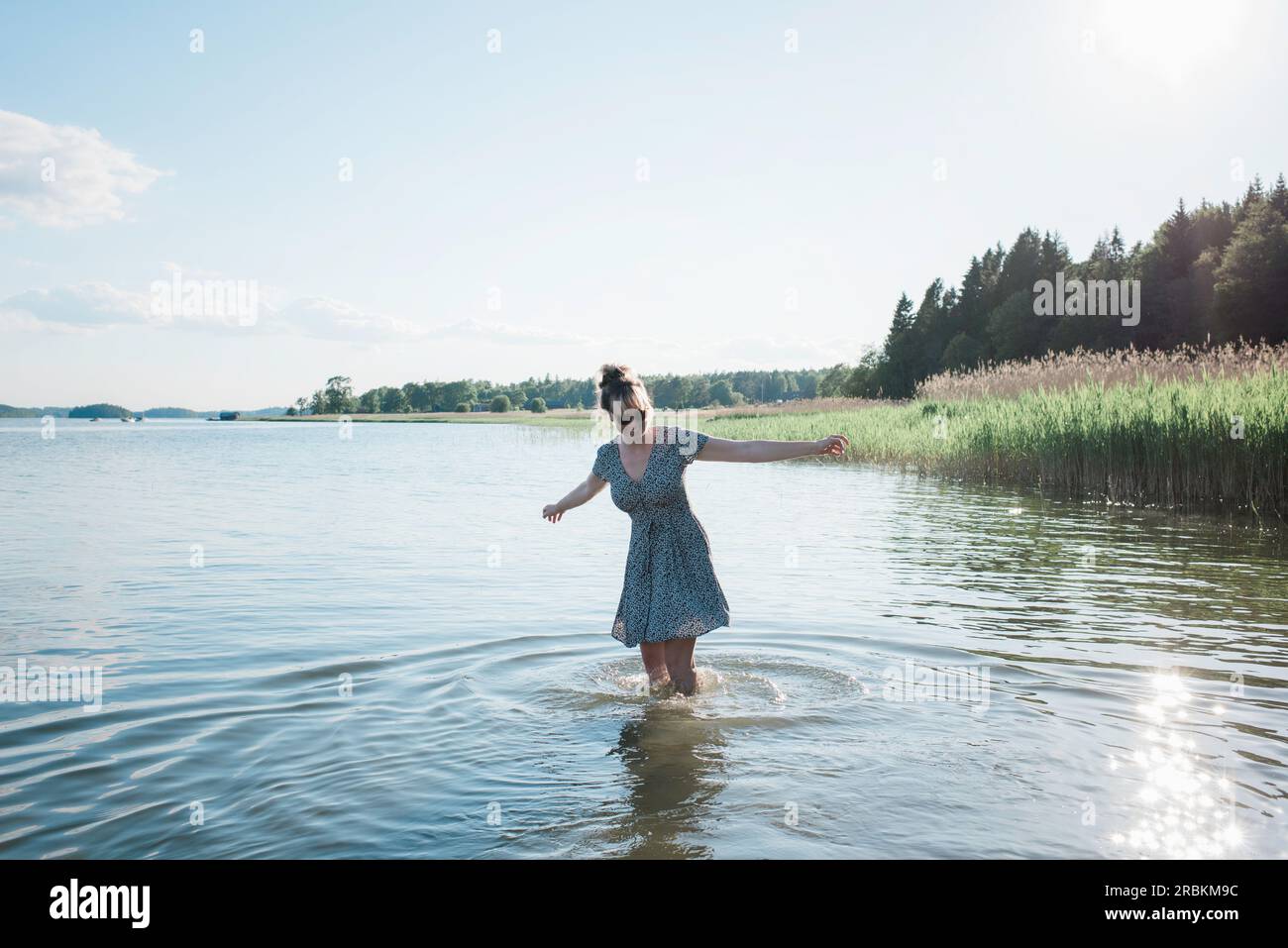 woman dancing in the water at the beach Stock Photo