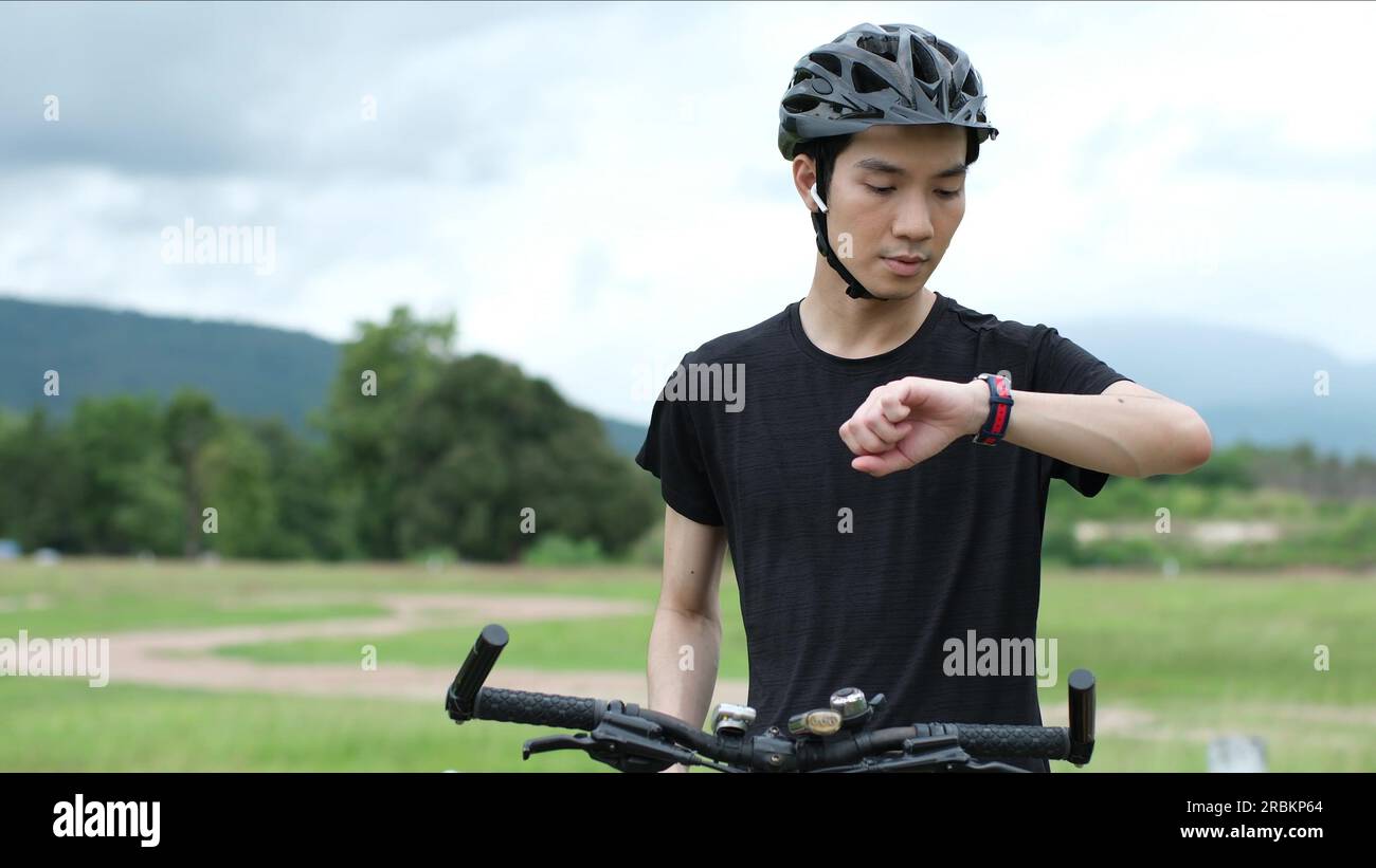 Sports man biker using GPS activity tracker fitness watch at training ...