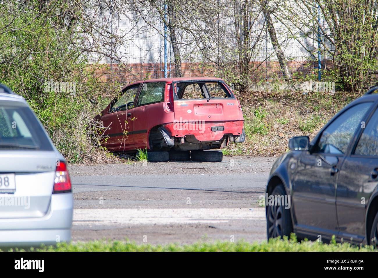 OSTRAVA, CZECH REPUBLIC - APRIL 22, 2023: Wreck of red Fiat Punto Italian Car with no wheels Stock Photo