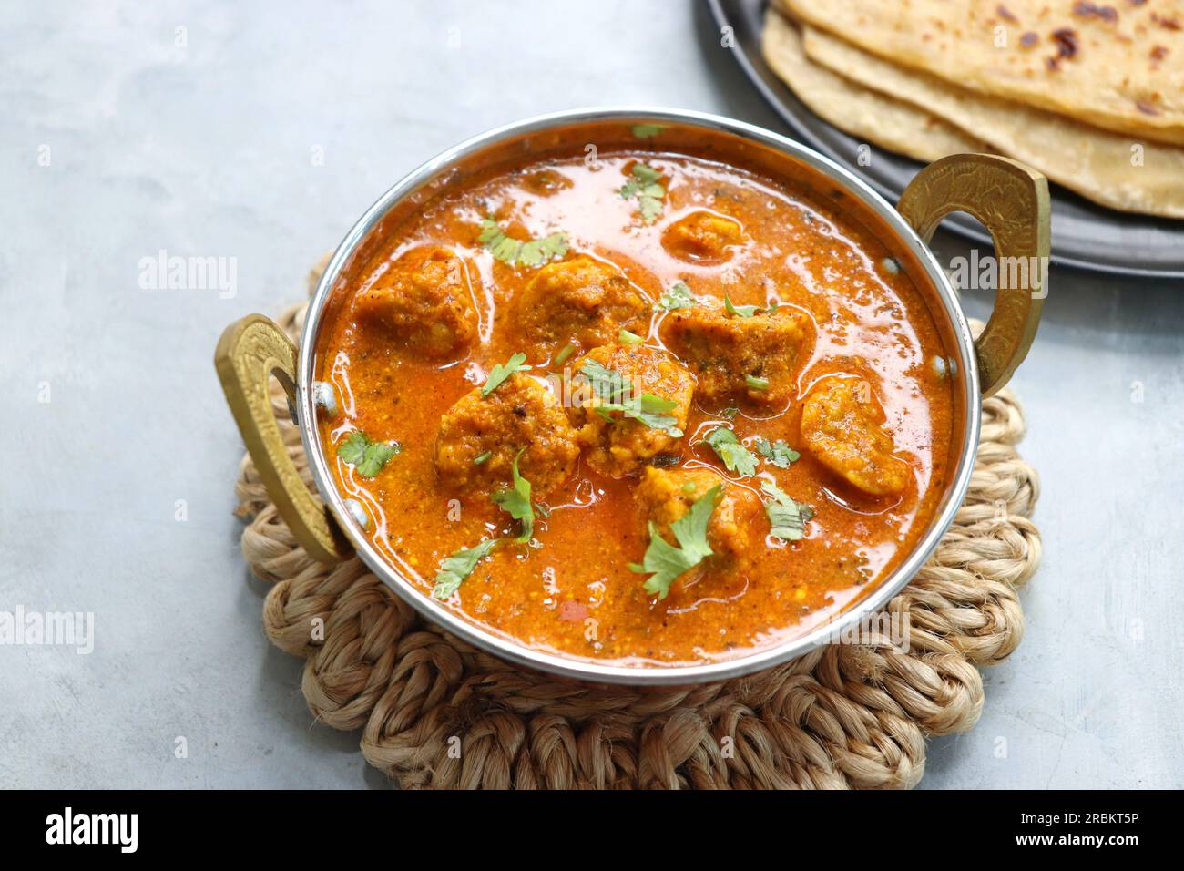 Rajasthani Gatta Curry or Besan Ke Gatte Ki Sabzi. Gatte are gram flour roundels or chickpea flour dumplings are cooked in a spicy, tangy yogurt curry Stock Photo