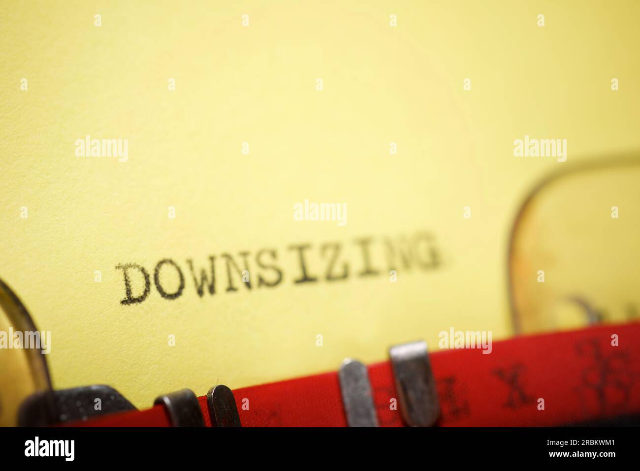 Downsizing word written with a typewriter. Stock Photo