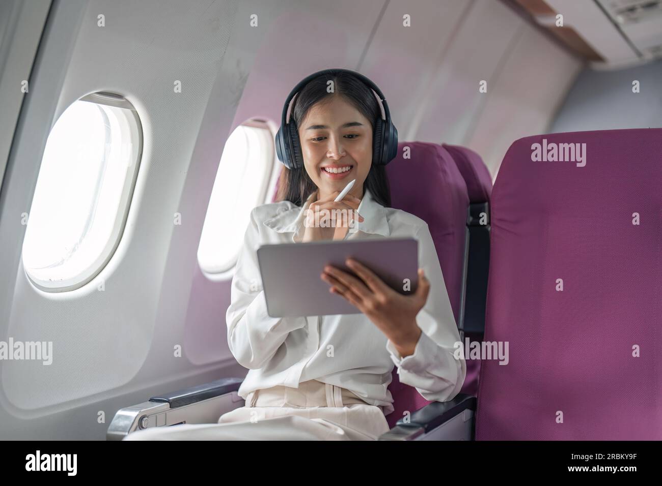Plane passenger business woman working in airplane cabin during flight