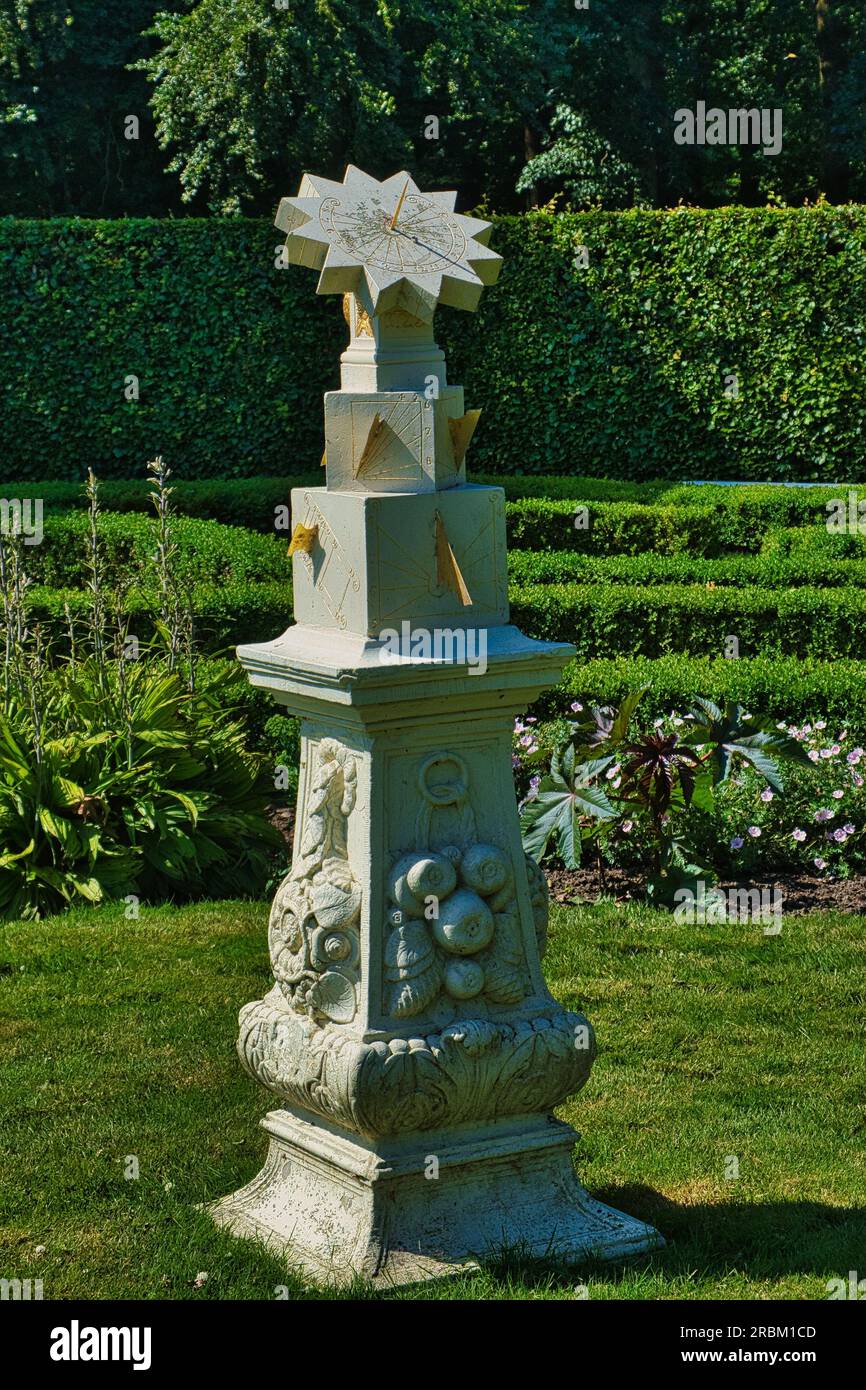 An 18th-century sandstone sun dial in a formal garden. Menkemaborg, Uithuizen, the Netherlands Stock Photo