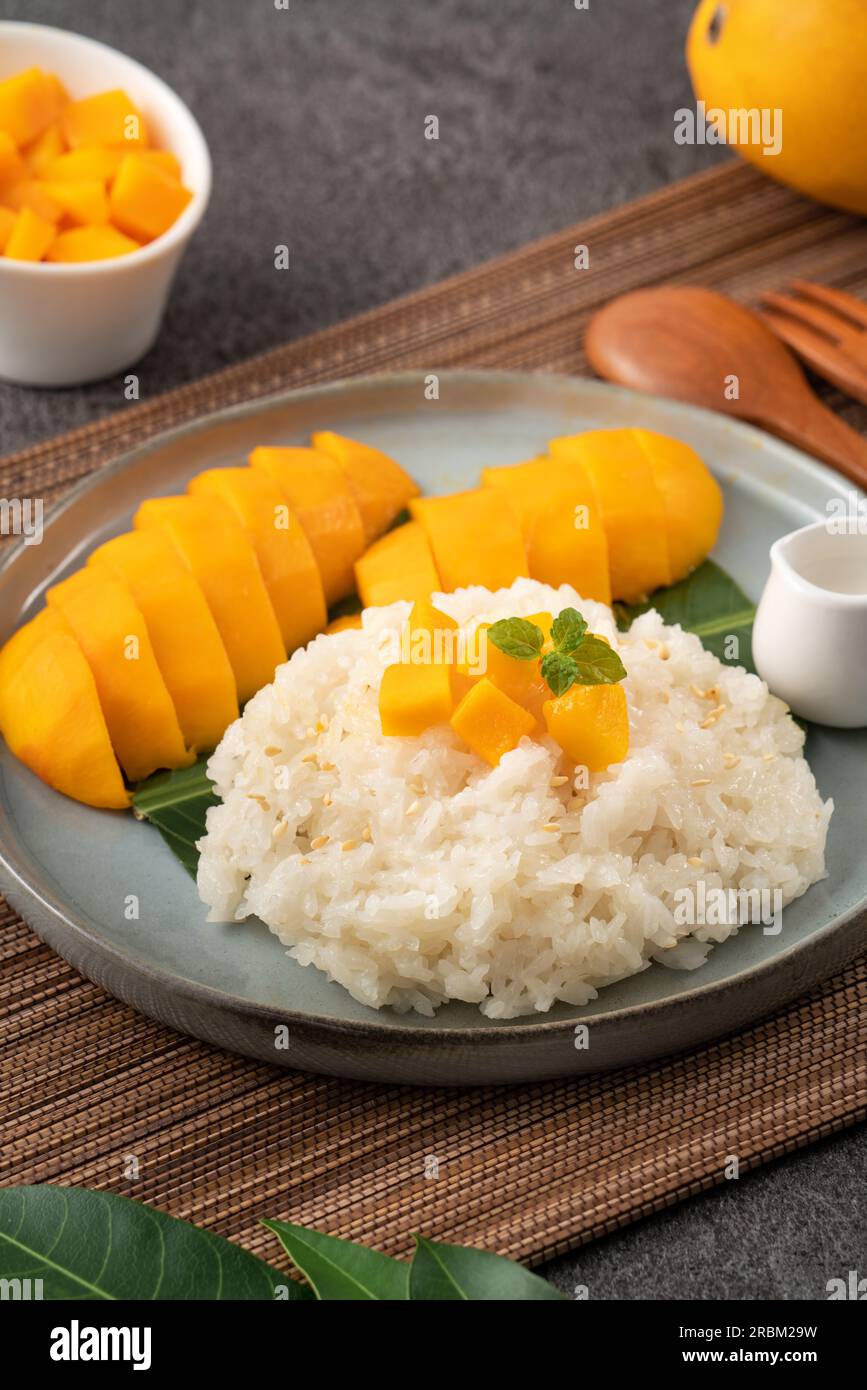 Delicious Thai mango sticky rice with cut fresh mango fruit in a plate ...