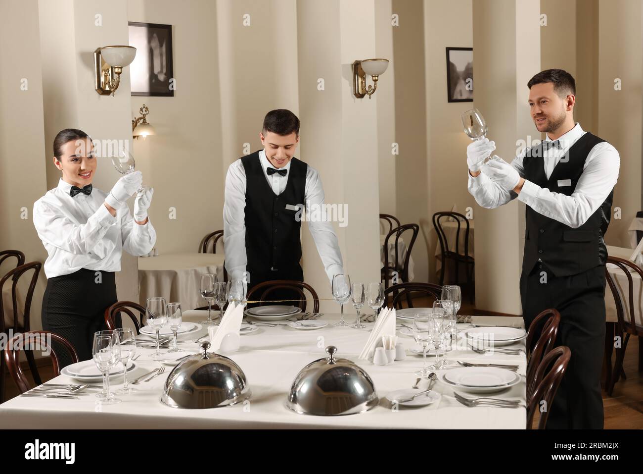 Group of people learning how to set table during professional butler Group of people learning how to set table during professional butler