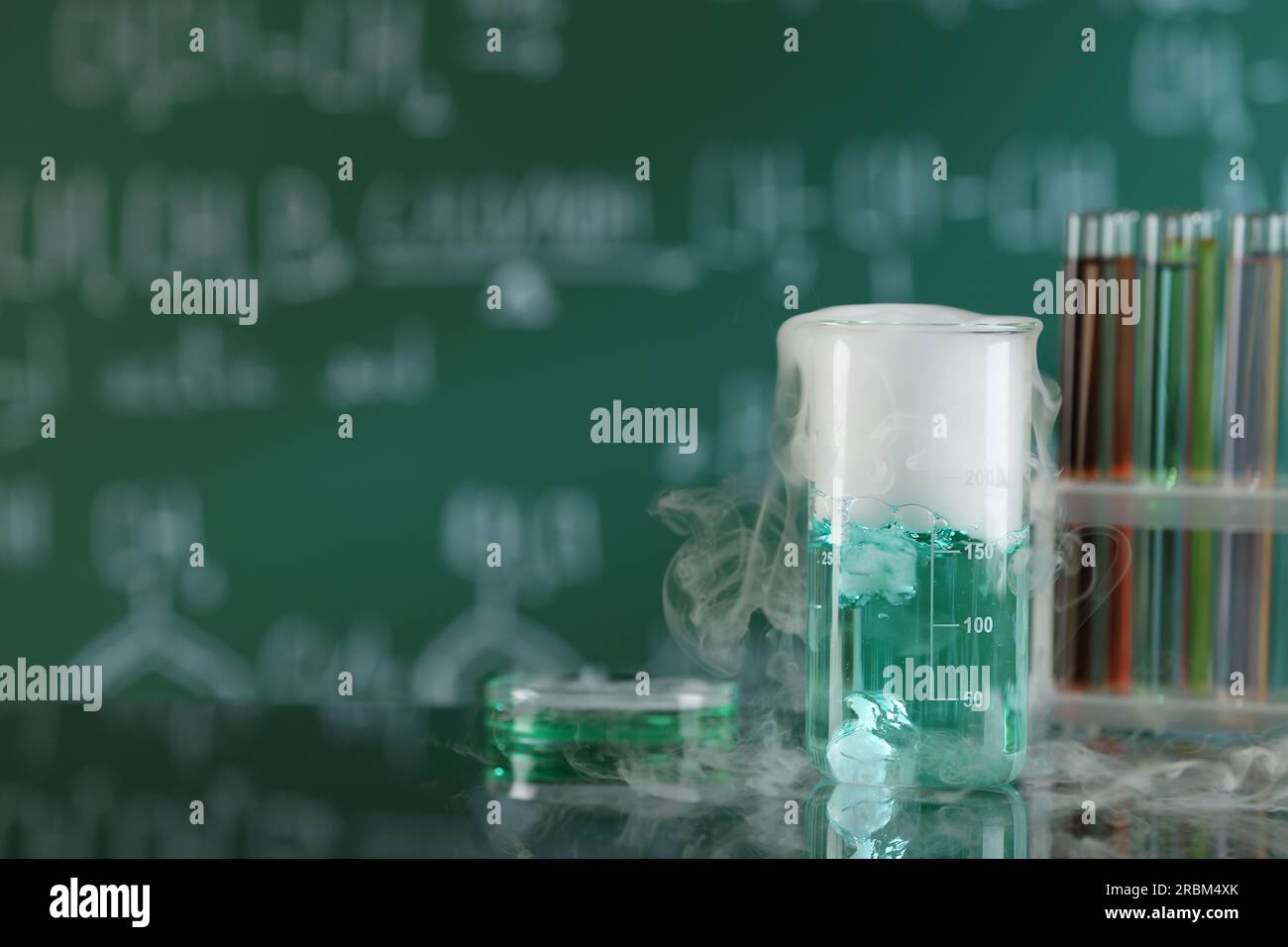 Laboratory glassware and test tubes with colorful liquids on glass ...