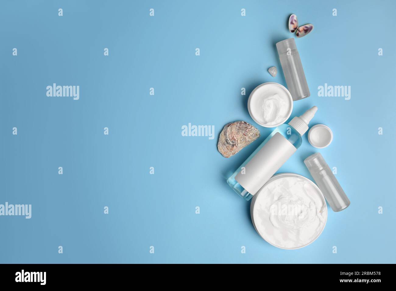 Flat lay composition with different cosmetic products on light blue ...
