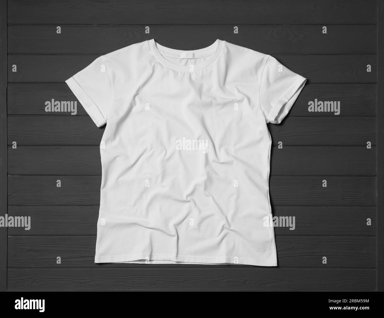 Stylish white T-shirt on gray wooden table, top view Stock Photo