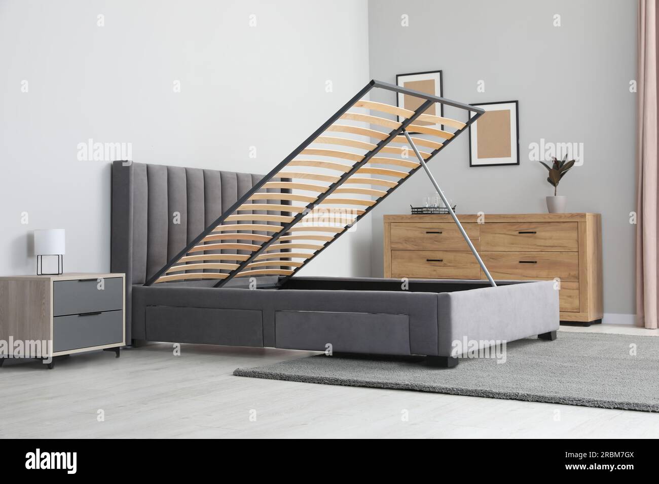 Comfortable bed with storage space for bedding under lifted slatted