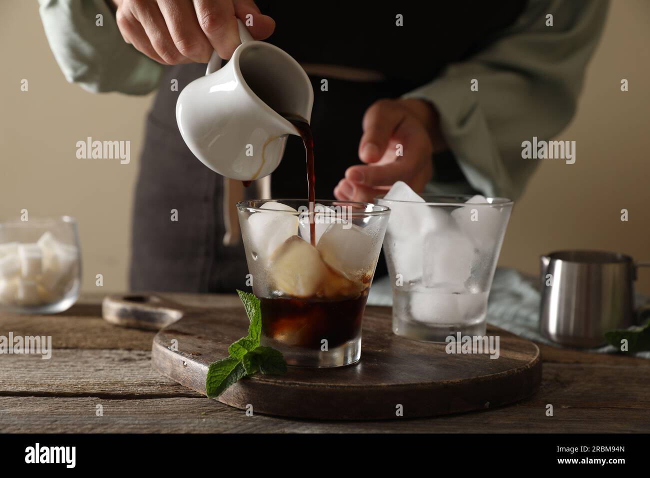 pour from a shaker Coffee frappe in a tall glass with ice Stock Photo -  Alamy
