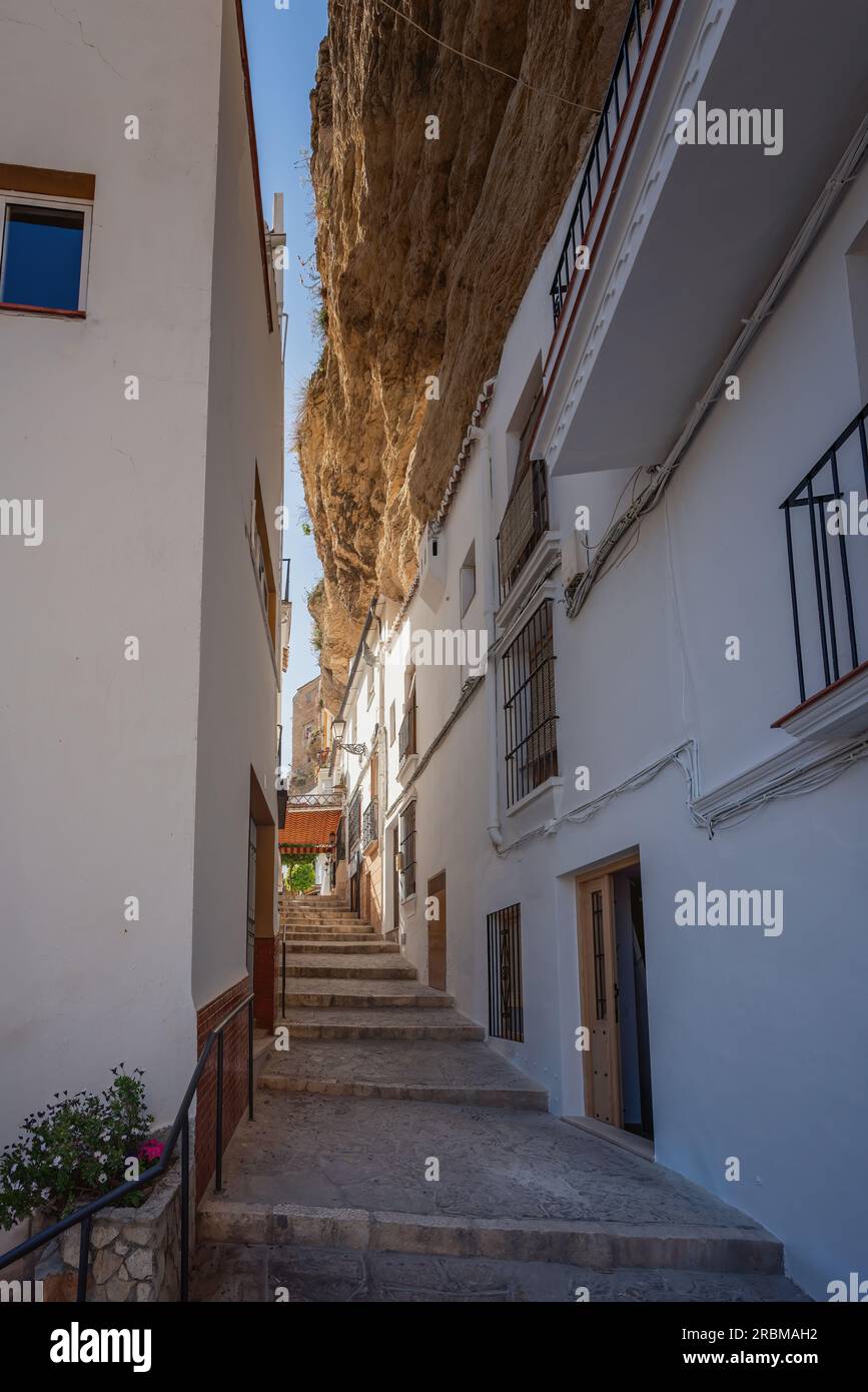 Stairs at Calle Herreria Street with Rocks dwellings - Setenil de las Bodegas, Andalusia, Spain Stock Photo