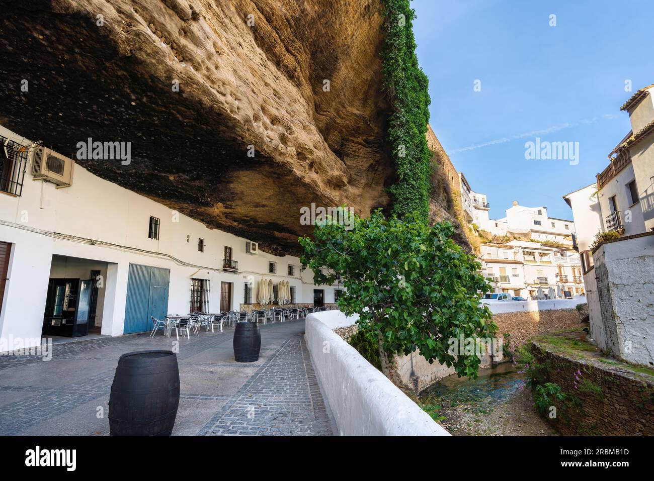 Calle Cuevas del Sol Street with Rocks dwellings and restaurants - Setenil de las Bodegas, Andalusia, Spain Stock Photo