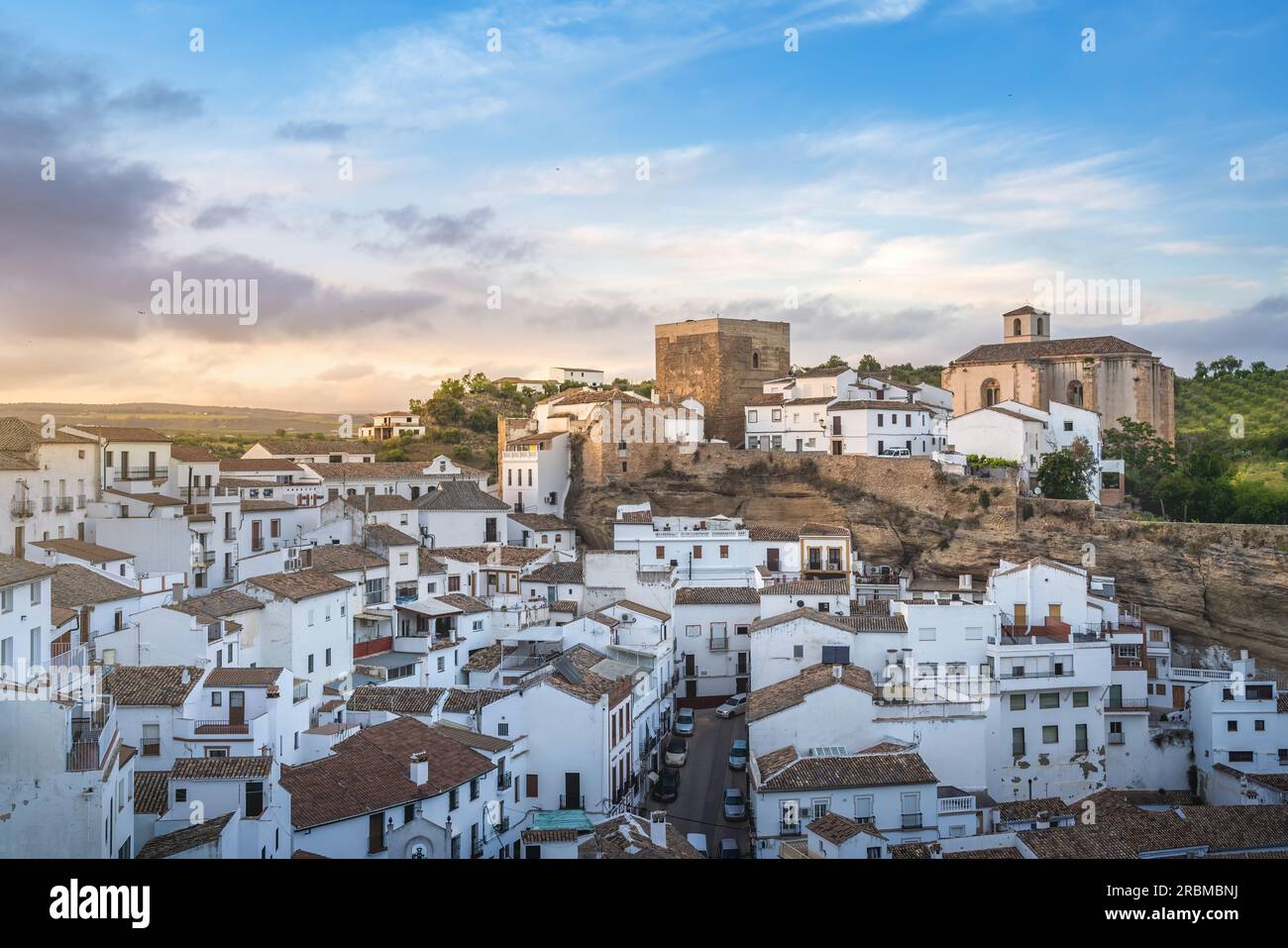 Skyline at sunset with Church of la Encarnacion and Torreon del Homenage Tower - Setenil de las Bodegas, Andalusia, Spain Stock Photo