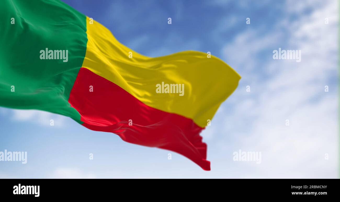 National flag of Benin waving on a clear day. Two horizontal yellow and red bands on the fly side and a green vertical band at the hoist. 3d illustrat Stock Photo