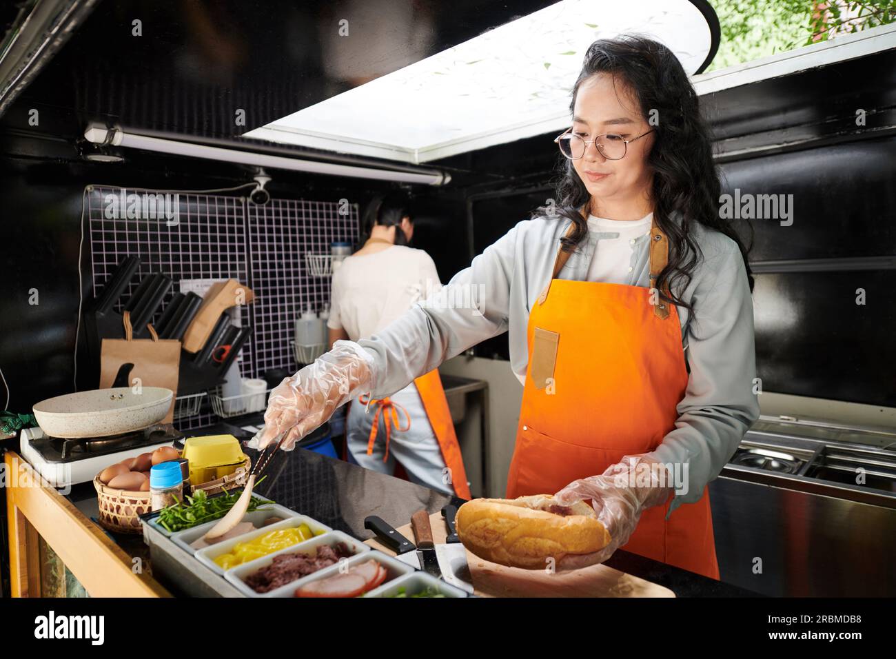 Food truck worker making ham sandwich for customer Stock Photo Alamy