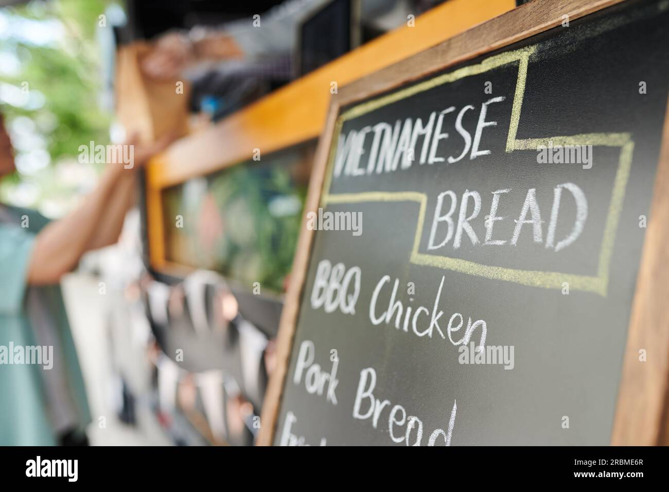 Chalkboard with menu of traditional Vietnamese bread food truck Stock
