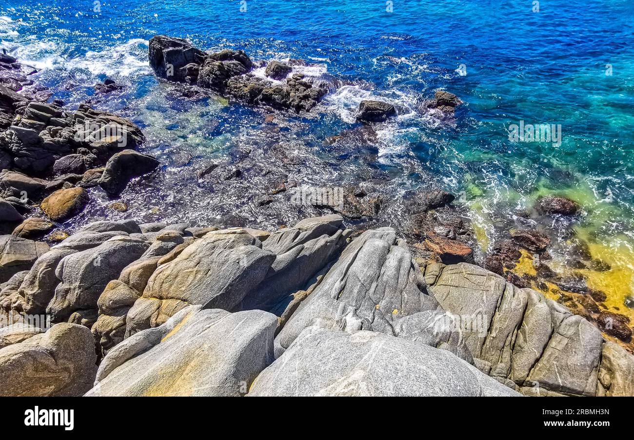 Beach sand turquoise blue water rocks cliffs boulders palm trees huge