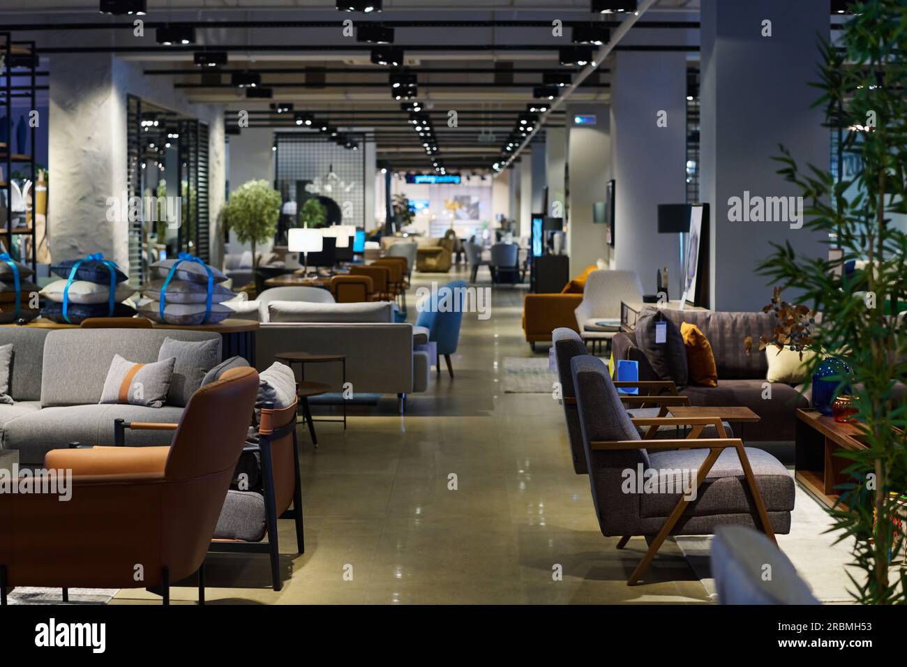 Side view of spacious lobby or coworking area with long aisle dividing ...