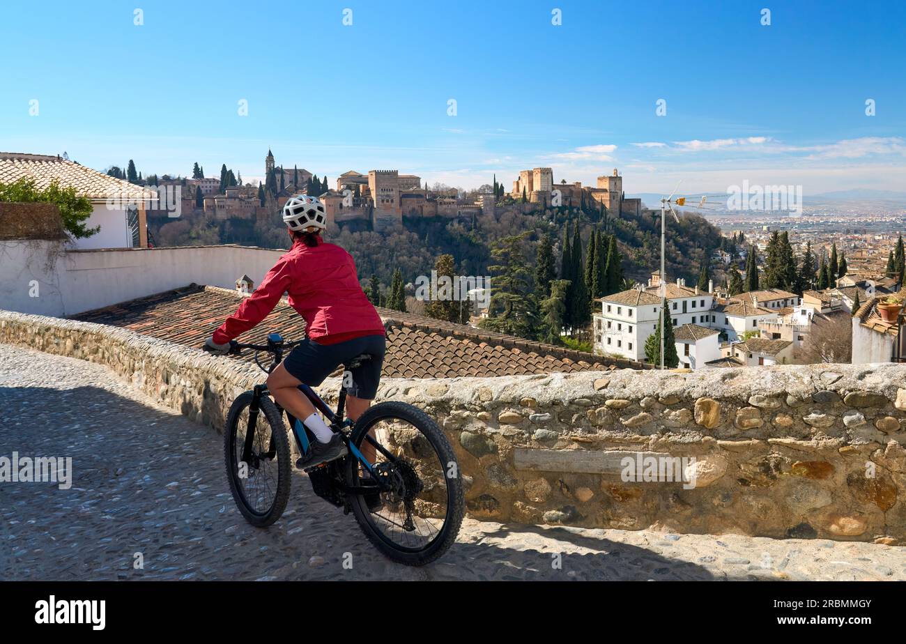 nice active senior woman cycling with her electric mountain bike in