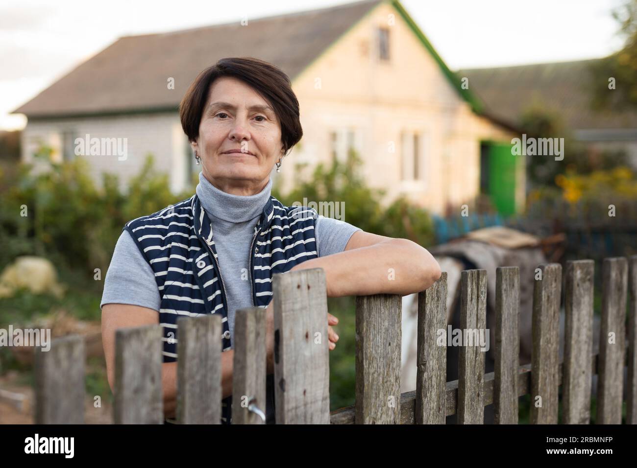 Elderly woman garden fence hi-res stock photography and images - Alamy