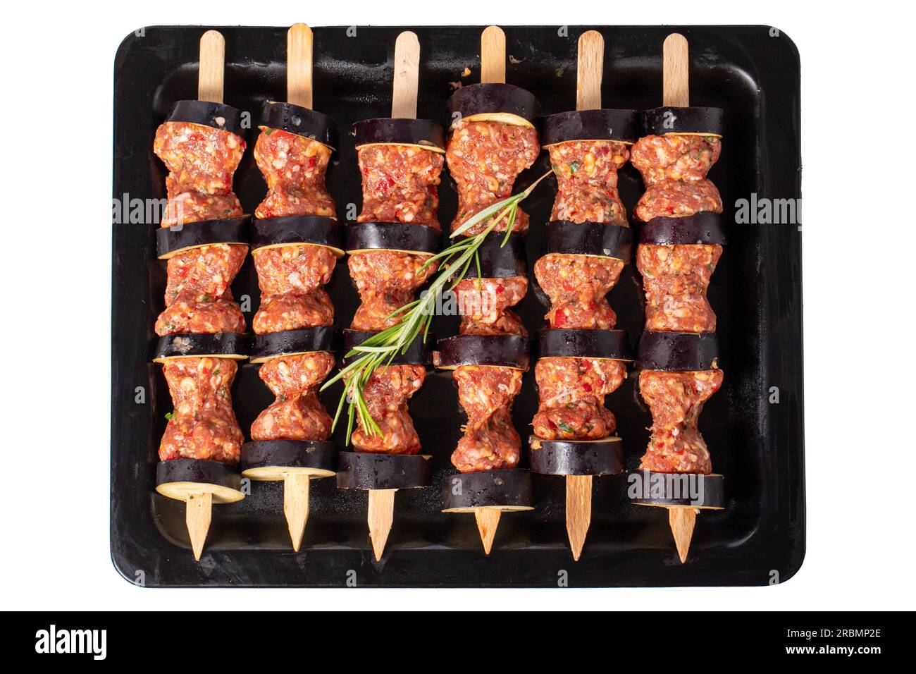 Eggplant kebab. Eggplant shish kebab with raw minced meat isolated on