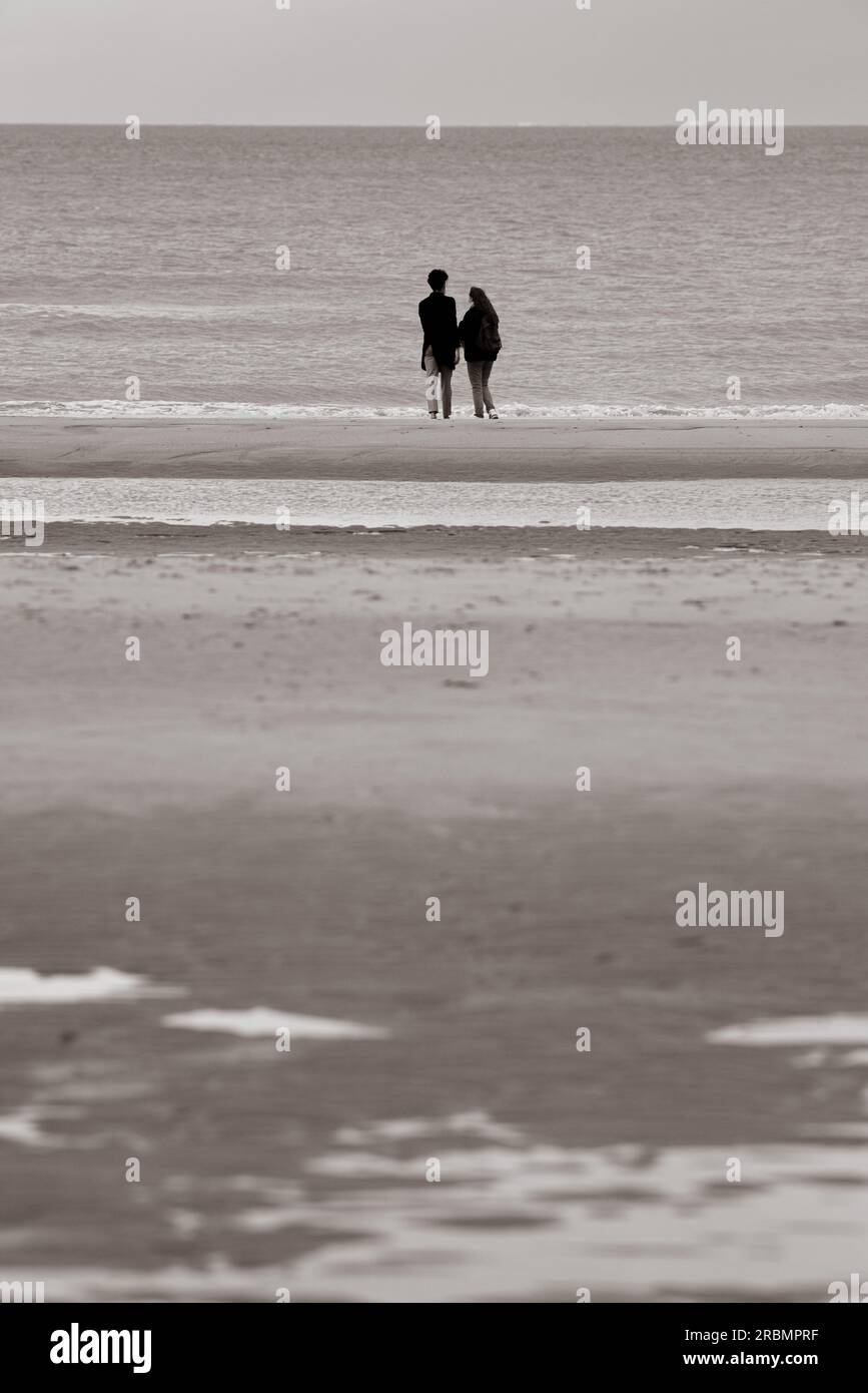 Couple looking at the sea in Ostend, Belgium. Stock Photo