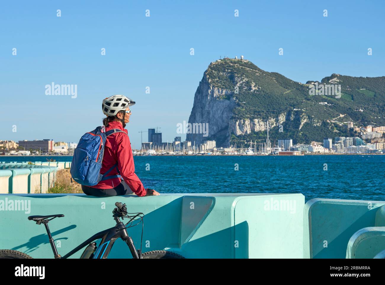happy senior woman cycling with her electric mountain bike below the