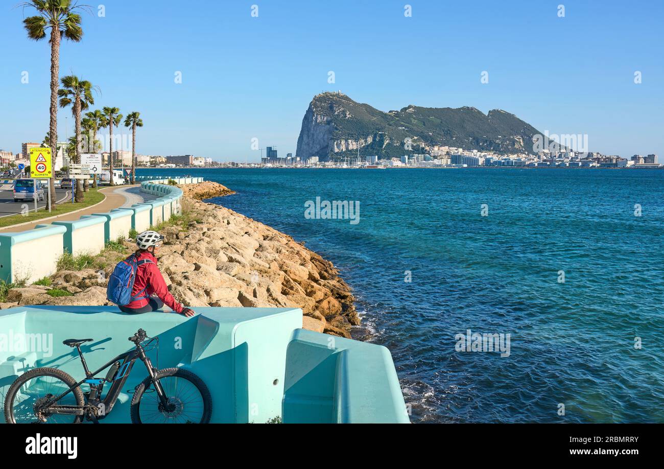 happy senior woman cycling with her electric mountain bike below the