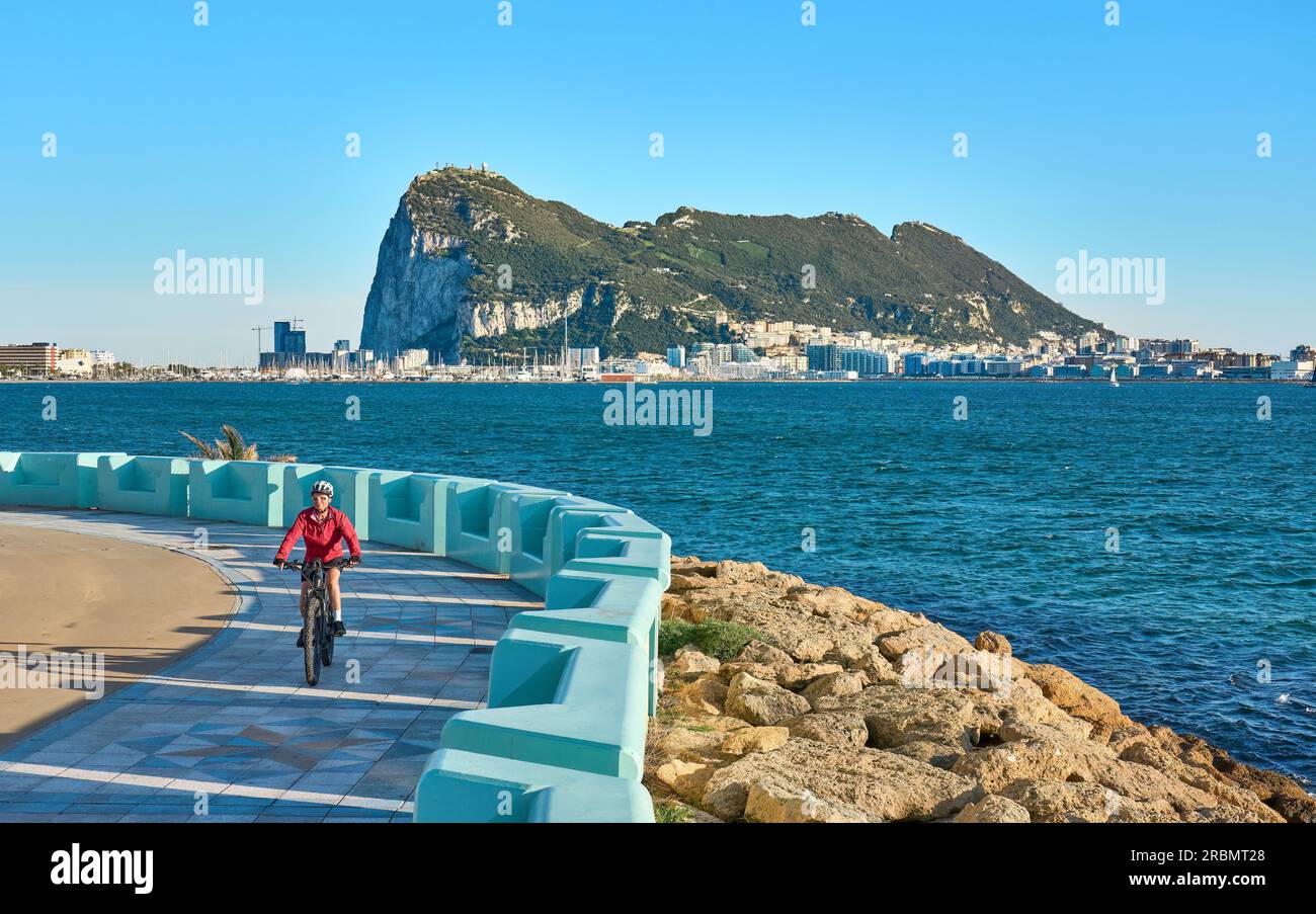 happy senior woman cycling with her electric mountain bike below the