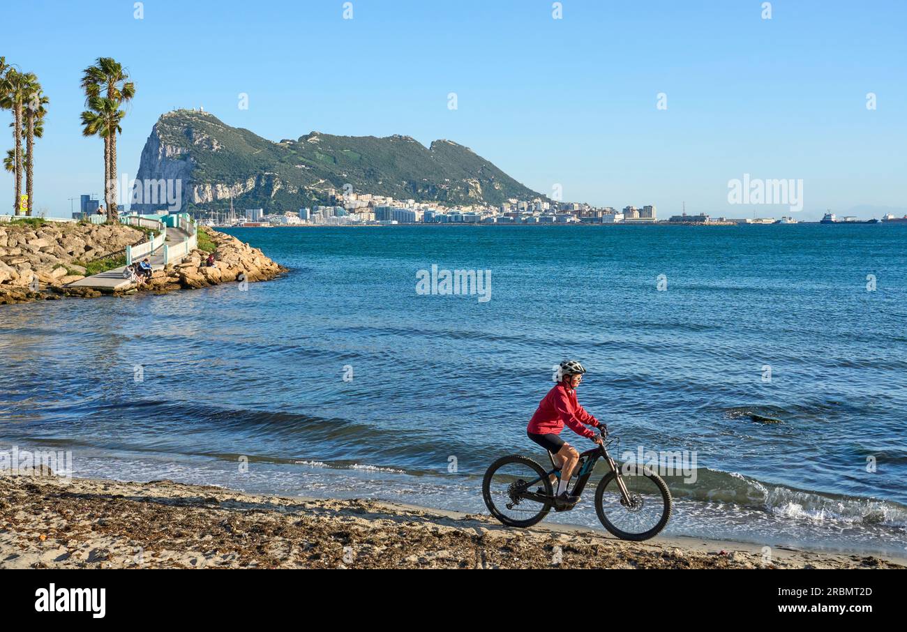 happy senior woman cycling with her electric mountain bike below the